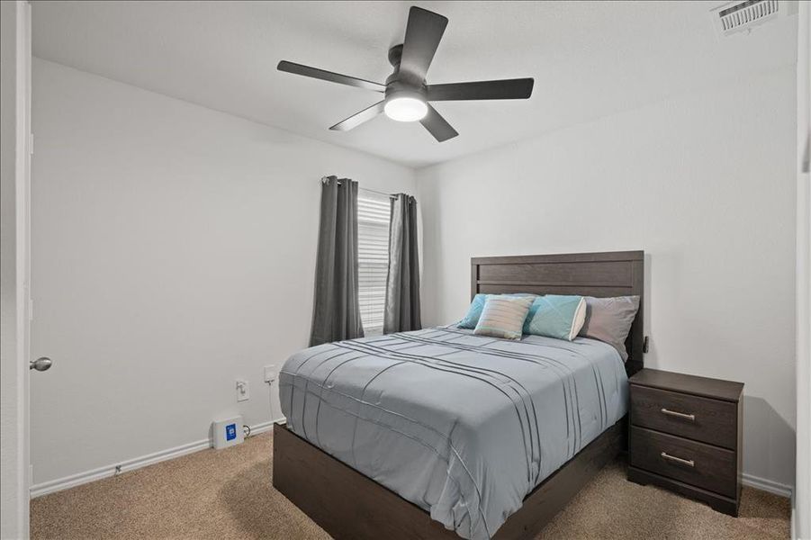 Bedroom featuring carpet flooring and a ceiling fan Bedroom featuring carpet flooring and a ceiling fan
