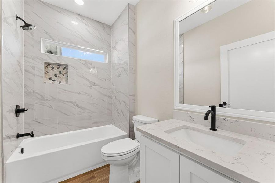 Bathroom featuring washtub / shower combination and vanity