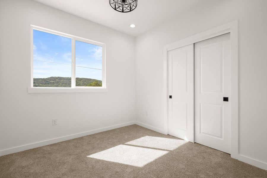 Unfurnished bedroom featuring carpet floors, recessed lighting, and a closet