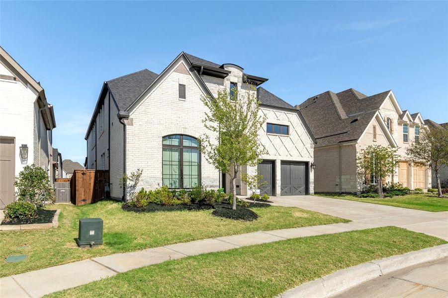 Front exterior of a new home in The Tribute 60', The Colony, TX, highlighting curb appeal (Image 2). Front exterior of a new home in The Tribute 60', The Colony, TX, highlighting curb appeal (Image 2).