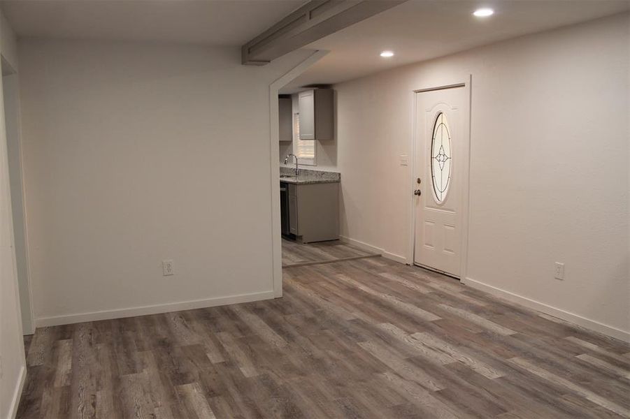 Entrance foyer with light wood-type flooring and recessed lighting