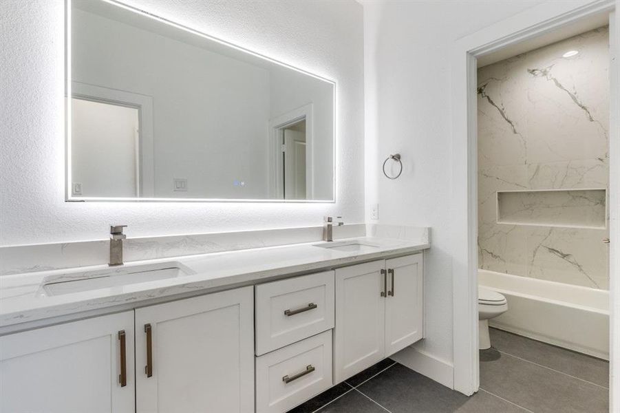 Full bathroom featuring vanity, tile patterned floors, toilet, and shower / bath combination