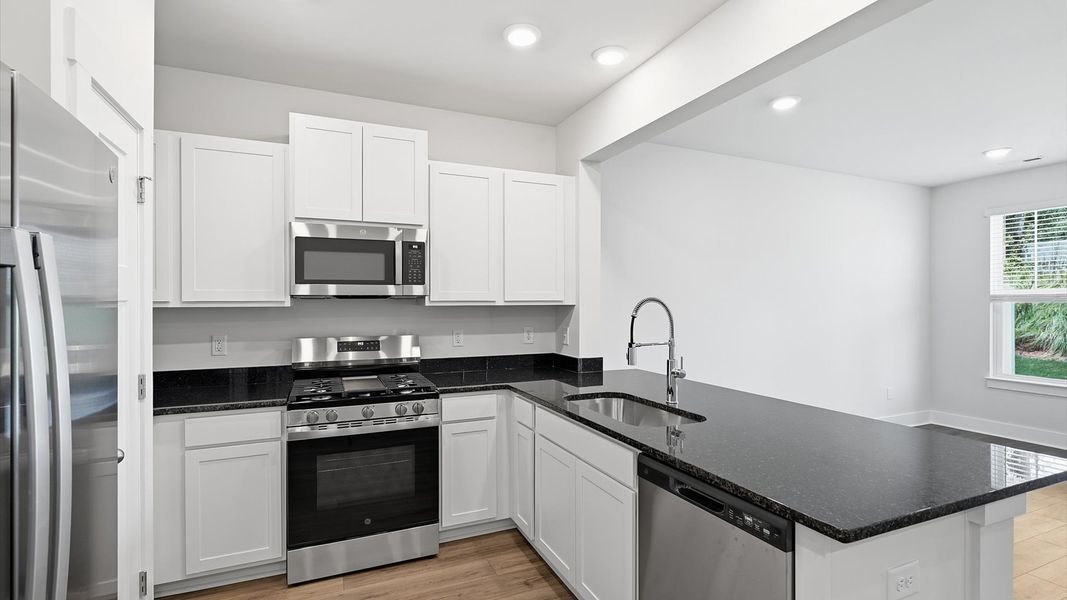 Bright and airy culinary space with generous prep areas and contemporary lighting at Clarke Townes