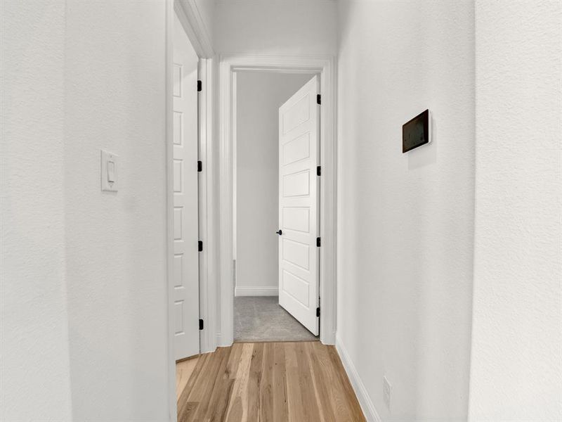 Hall with light wood-style floors and baseboards Hall with light wood-style floors and baseboards