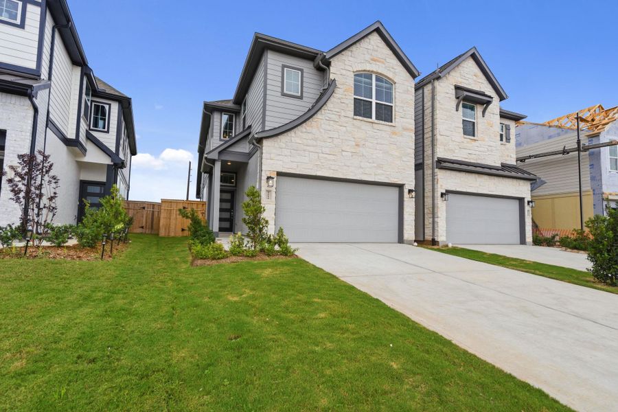Front exterior of a new home in Sienna, Missouri City, TX, highlighting curb appeal (Image 21). Front exterior of a new home in Sienna, Missouri City, TX, highlighting curb appeal (Image 21).