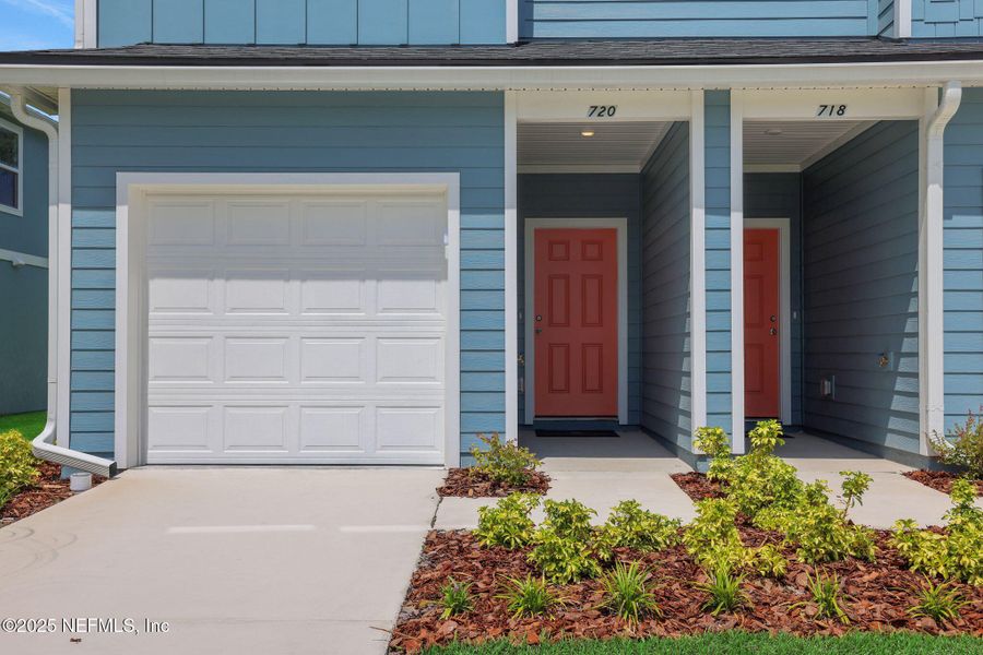 Front exterior of a new home in Kasen Oaks, Jacksonville, FL, highlighting curb appeal (Image 1).