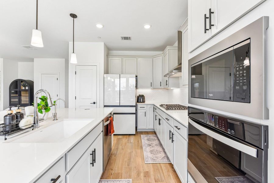 Culinary delights await in this bright kitchen with modern appliances and abundant counter space.