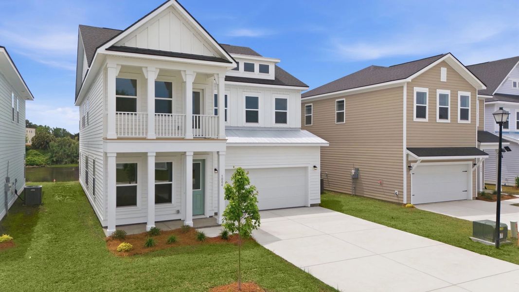 Front exterior of a new home in Blue Heron Retreat, Little River, SC, highlighting curb appeal (Image 2). Front exterior of a new home in Blue Heron Retreat, Little River, SC, highlighting curb appeal (Image 2).