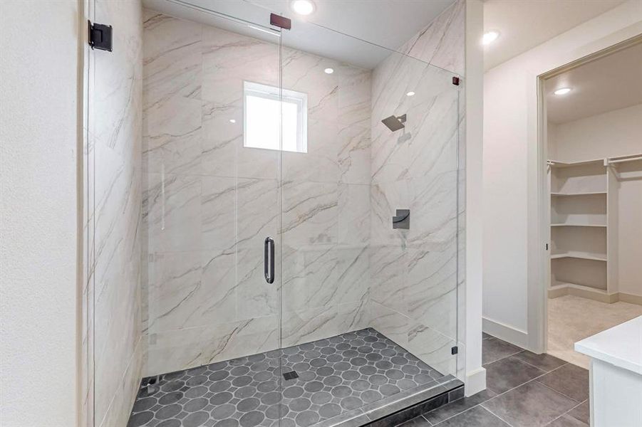 Bathroom featuring walk in shower, tile patterned floors, and vanity