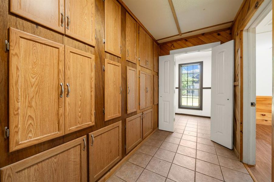 Hallway storage leading to laundry and primary bedroom.