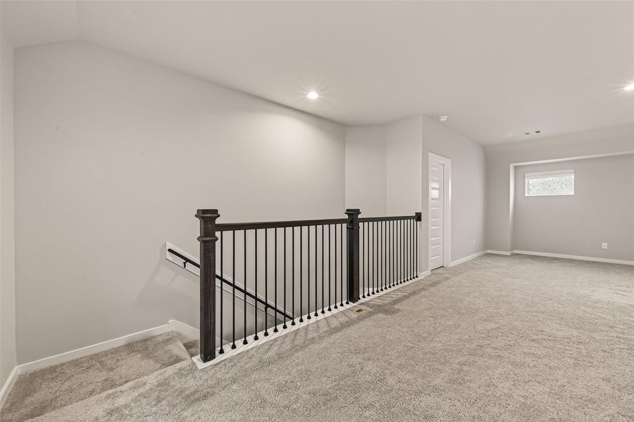 This view shows the staircase rising from the first floor, connecting the main level to the upper rooms.