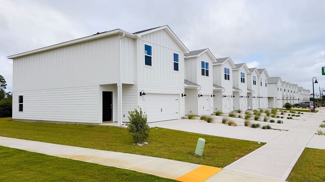Front exterior of a new home in Salt Creek Townhomes at Mexico Beach, Mexico Beach, FL, highlighting curb appeal (Image 17).