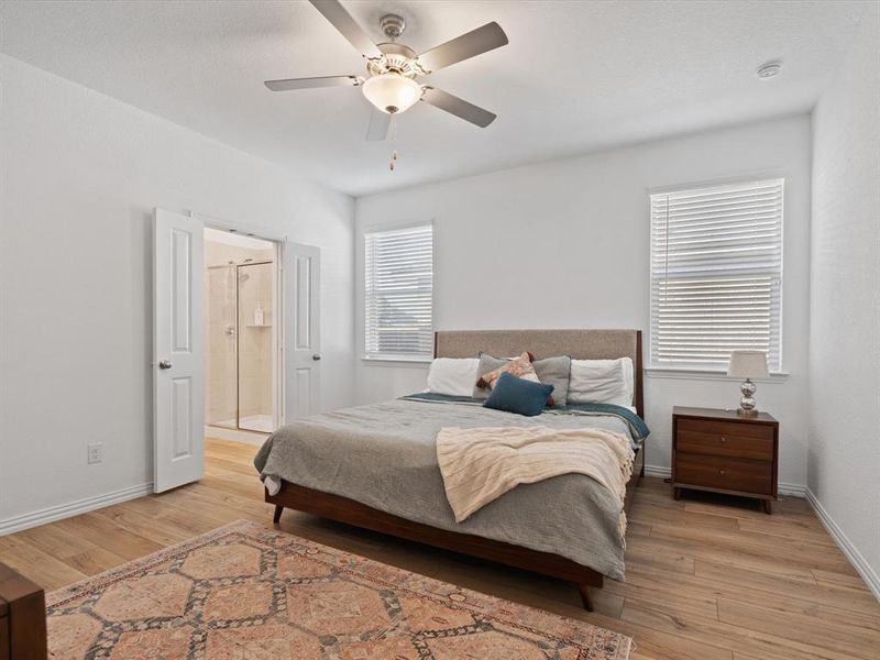 Bedroom with light hardwood / wood-style flooring and ceiling fan