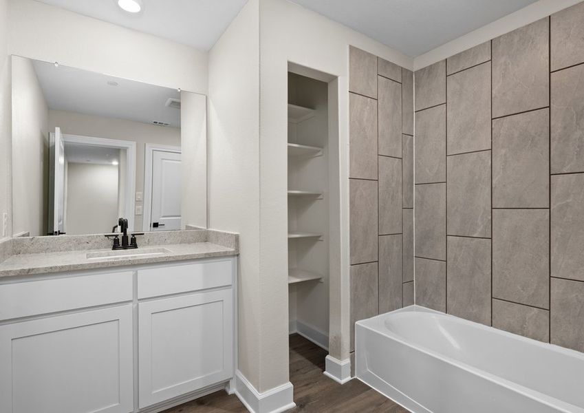 The secondary bathroom has a large vanity space.