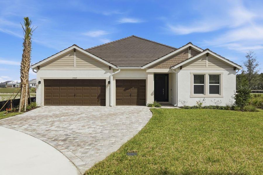Front exterior of a new home in Hammock at Two Rivers, Zephyrhills, FL, highlighting curb appeal (Image 21).