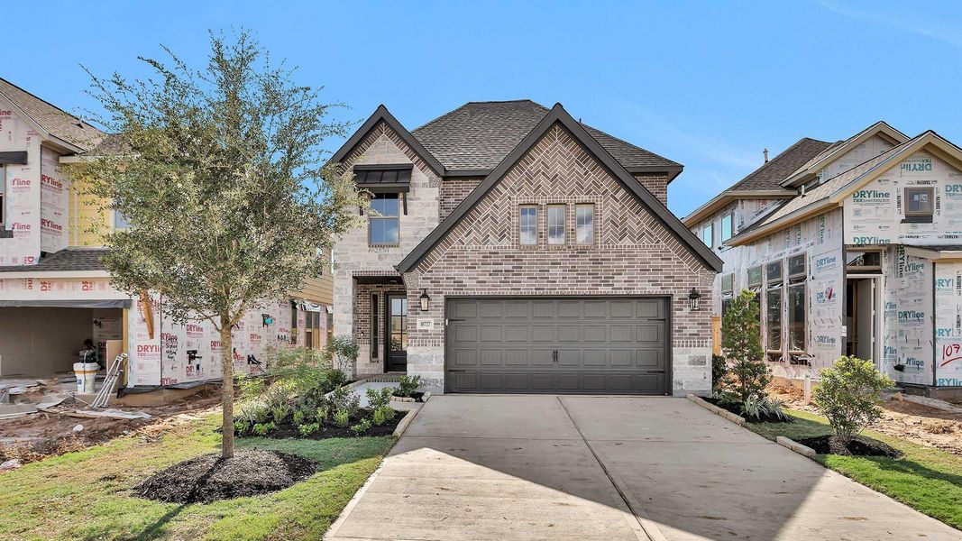 Front exterior of a new home in Candela 40', Richmond, TX, highlighting curb appeal (Image 8). Front exterior of a new home in Candela 40', Richmond, TX, highlighting curb appeal (Image 8).