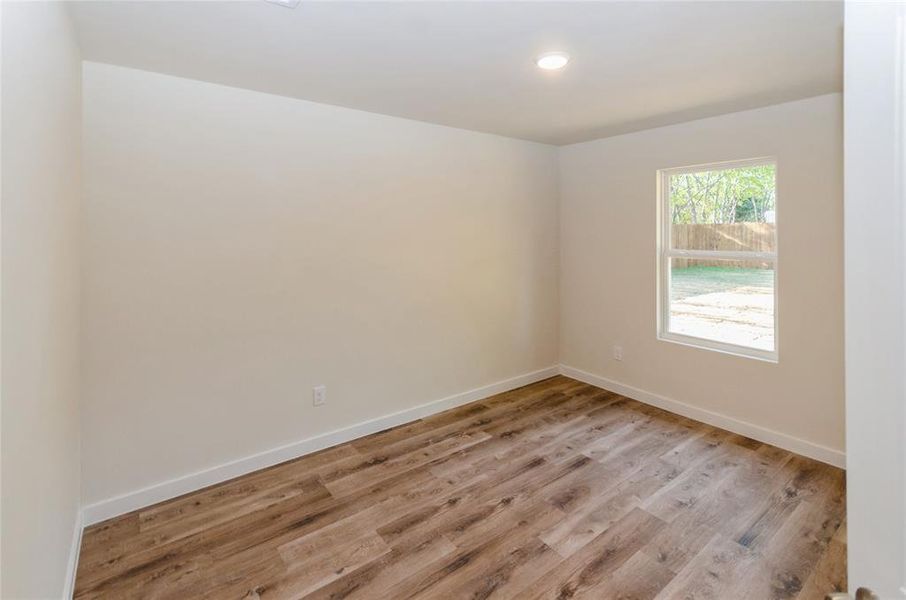 Spare room featuring light wood-type flooring