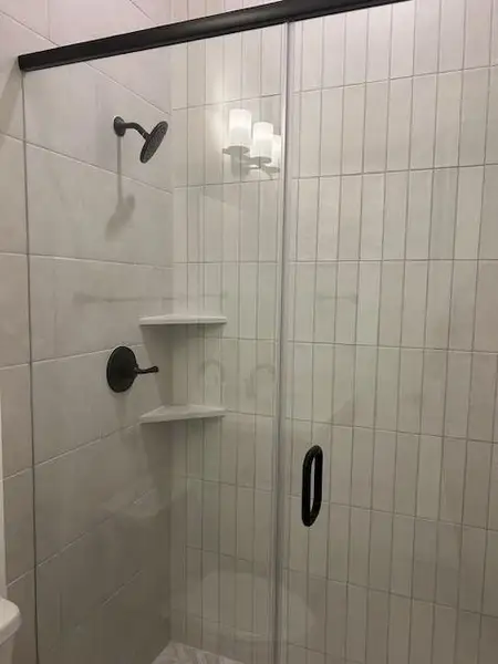 Second bath downstairs offers a free standing shower in lieu of a tub.