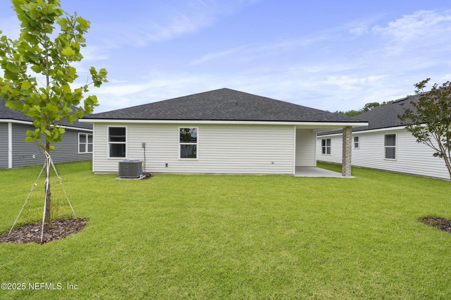 Front exterior of a new home in Summerglen, Jacksonville, FL, highlighting curb appeal (Image 1).