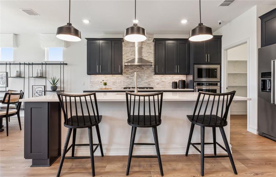 Spacious kitchen with eat-in bartop island *Model Representation*