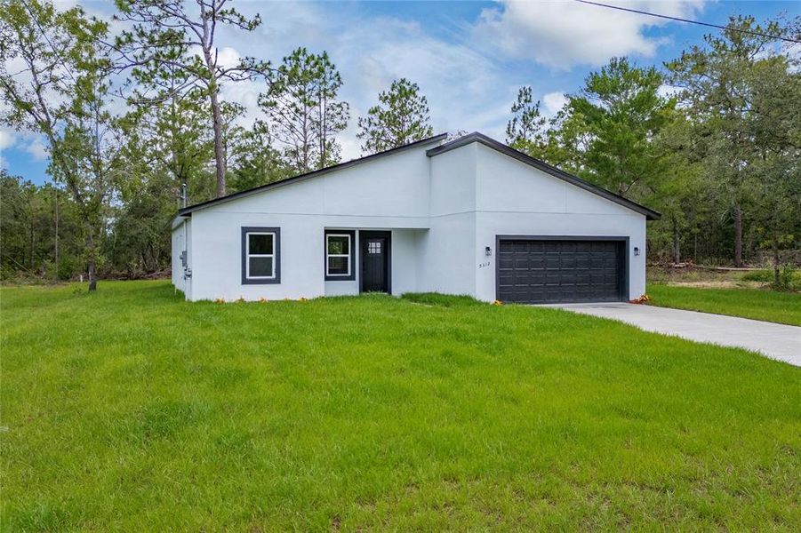 Front exterior of a new home in , Citrus Springs, FL, highlighting curb appeal (Image 18).