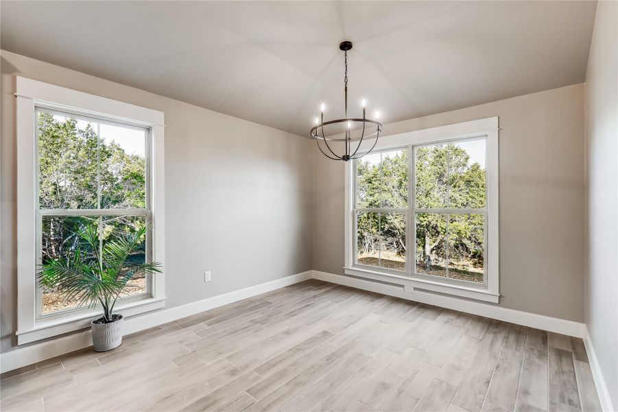 So bright and inviting- look how the windows go to the floor and the upgraded chandelier
