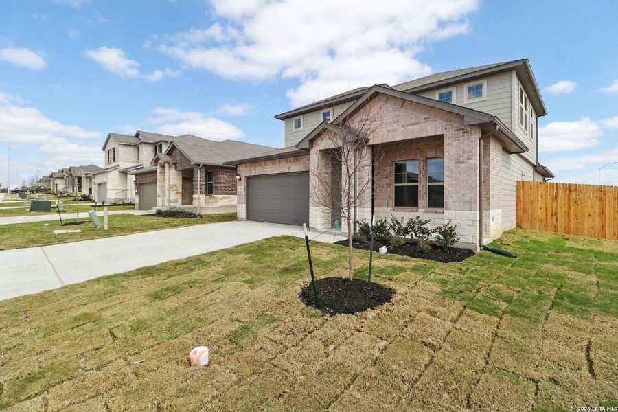 Front exterior of a new home in Legendary Trails - Premier Series, Cibolo, TX, highlighting curb appeal (Image 25).