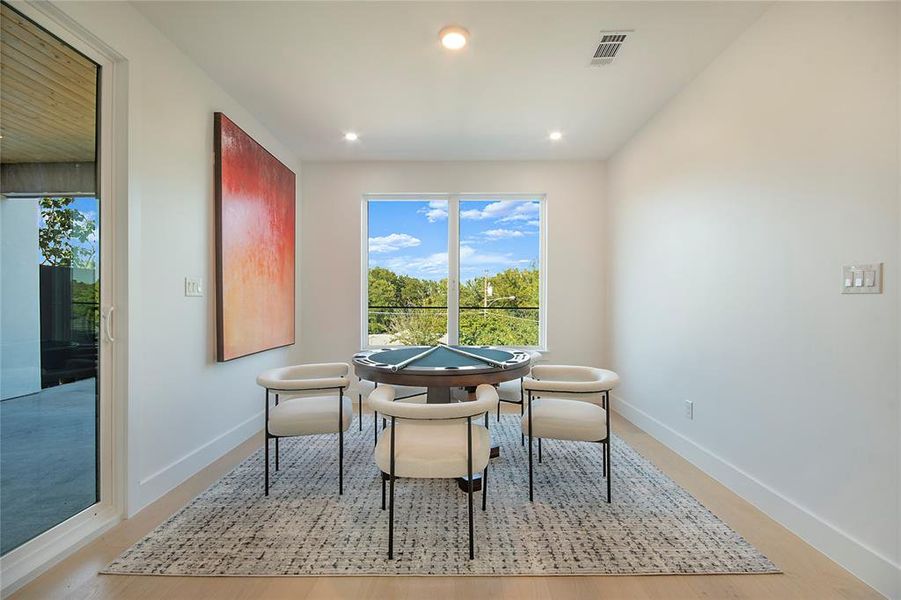 Dining area with light wood finished floors and recessed lighting Dining area with light wood finished floors and recessed lighting
