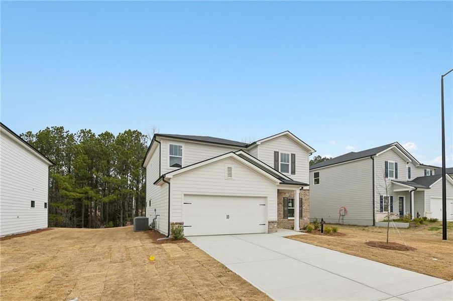 Front exterior of a new home in Ivey Township, Dallas, GA, highlighting curb appeal (Image 23).
