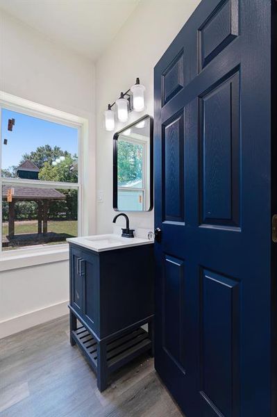 Bathroom featuring wood finished floors and vanity Bathroom featuring wood finished floors and vanity