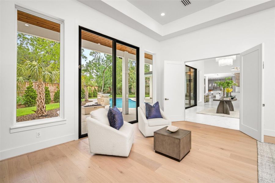 Sleek, remote-controlled ceiling fan and stunning 10-inch white oak floors add modern sophistication, while direct access invites you to unwind by the outdoor firepit or enjoy a refreshing morning swim. Sleek, remote-controlled ceiling fan and stunning 10-inch white oak floors add modern sophistication, while direct access invites you to unwind by the outdoor firepit or enjoy a refreshing morning swim.