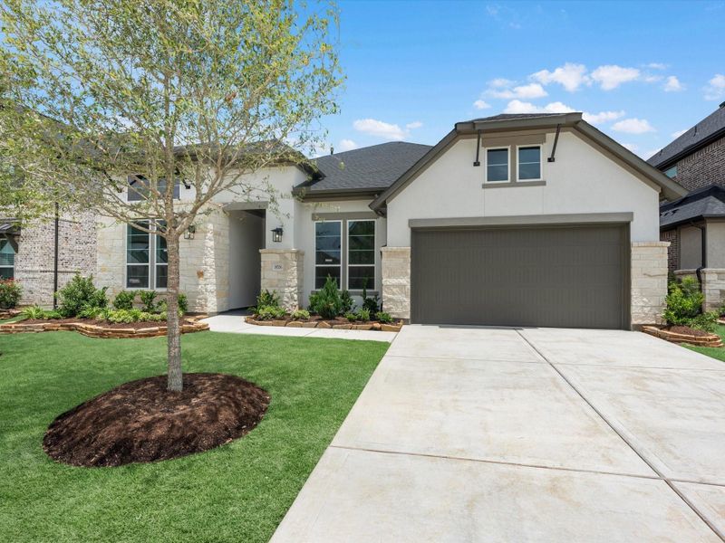 Front exterior of a new home in Dunham Pointe, Cypress, TX, highlighting curb appeal (Image 2). Front exterior of a new home in Dunham Pointe, Cypress, TX, highlighting curb appeal (Image 2).