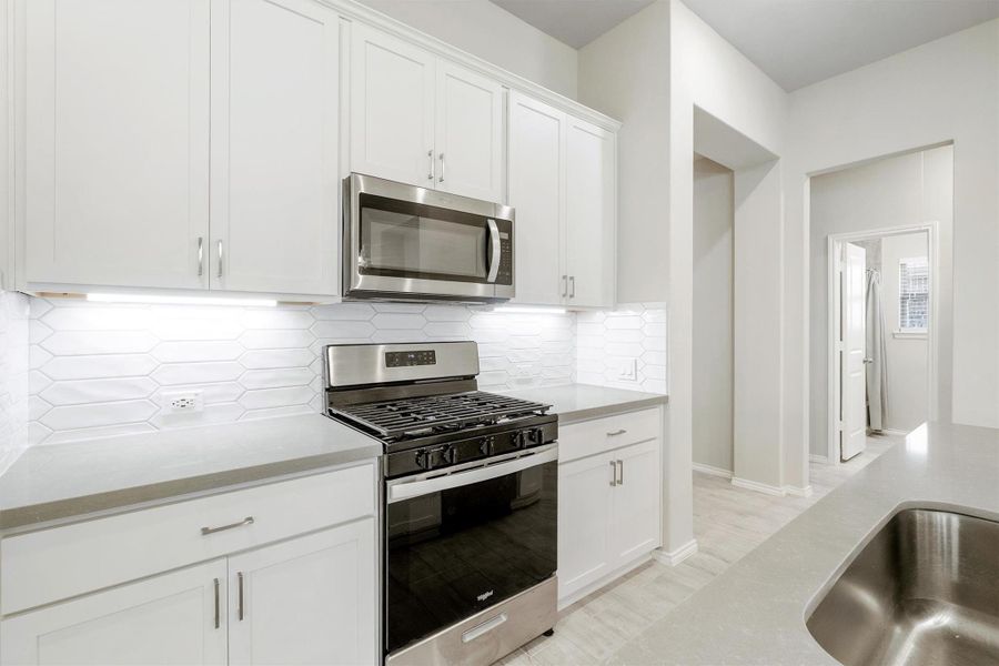 The details make the difference. Under-cabinet lighting and stainless steel appliances including a gas range and built-in microwave. Everything here was designed to make cooking feel less like a chore and more like a vibe. The details make the difference. Under-cabinet lighting and stainless steel appliances including a gas range and built-in microwave. Everything here was designed to make cooking feel less like a chore and more like a vibe.