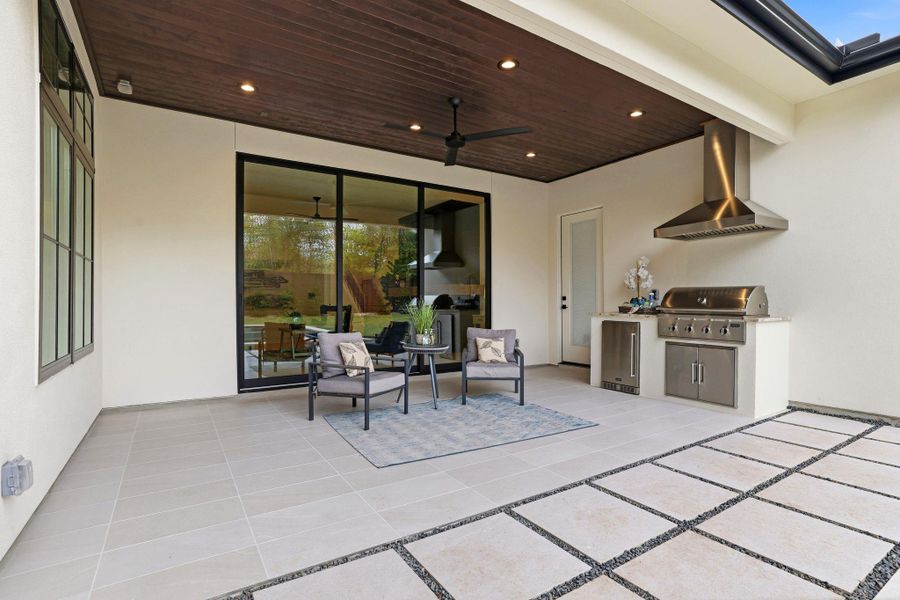 View of patio featuring an outdoor kitchen and ceiling fan