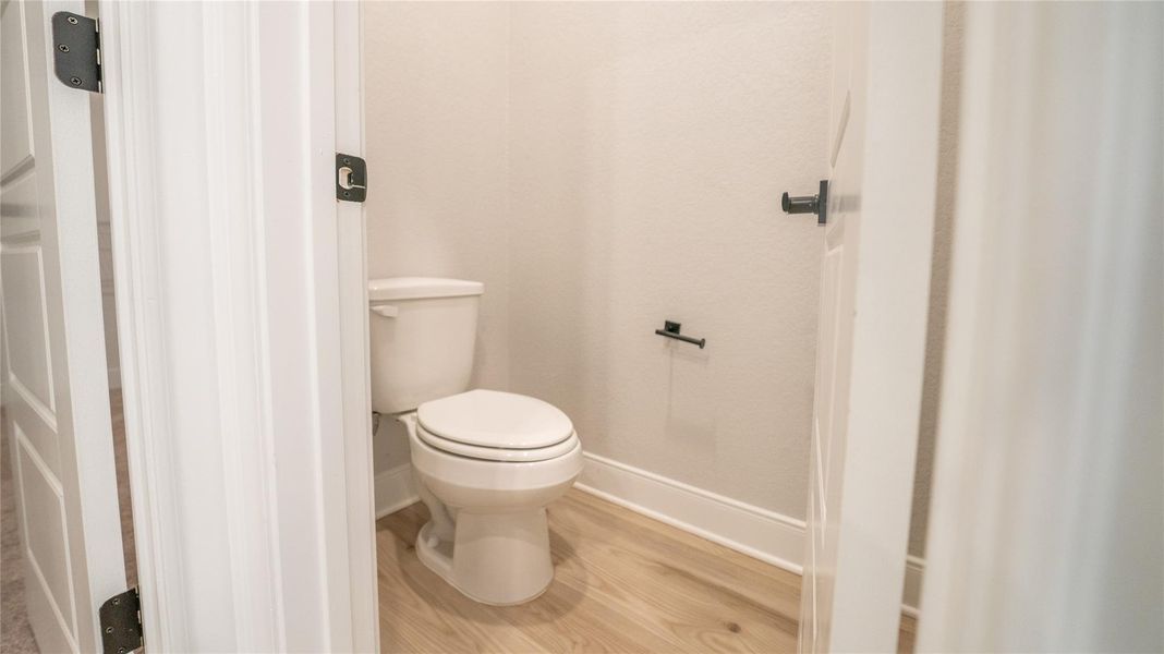Bathroom with wood finished floors and toilet Bathroom with wood finished floors and toilet