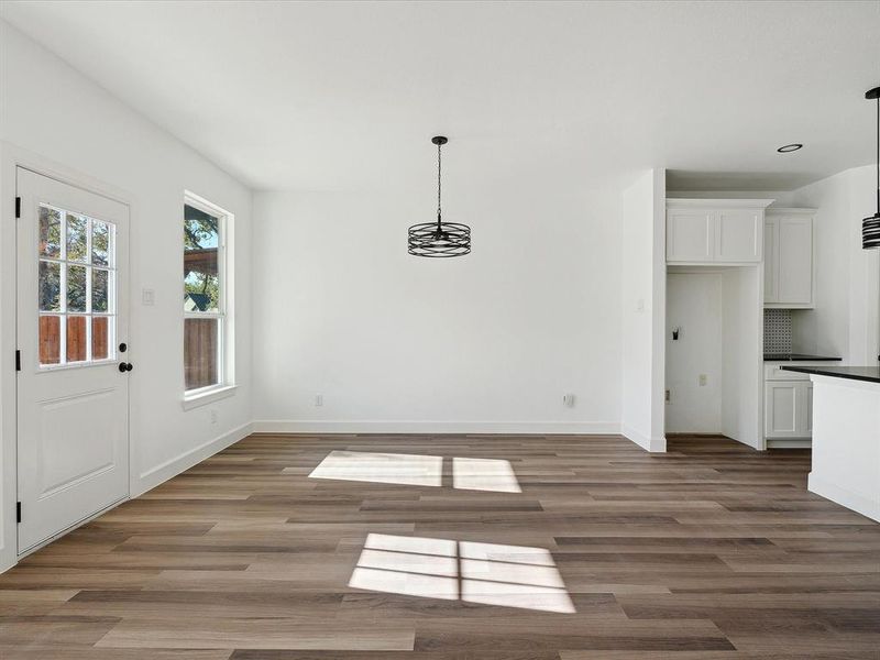 Unfurnished dining area featuring dark wood-type flooring