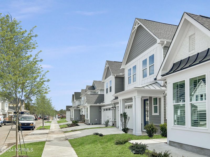 Front exterior of a new home in East & Mason, Wilmington, NC, highlighting curb appeal (Image 26). Front exterior of a new home in East & Mason, Wilmington, NC, highlighting curb appeal (Image 26).