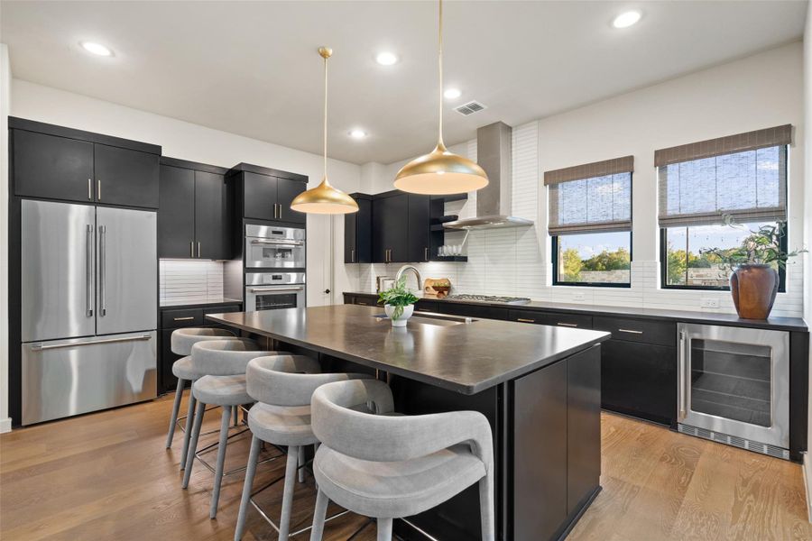 Culinary excellence awaits in this well-appointed kitchen, featuring a central island and a suite of high-end appliances.