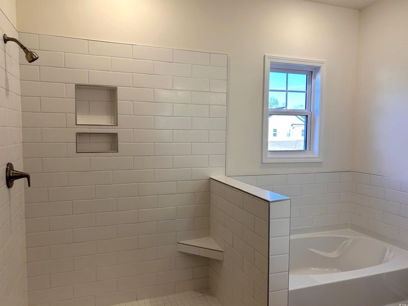 Full bath with a garden tub and a tile shower