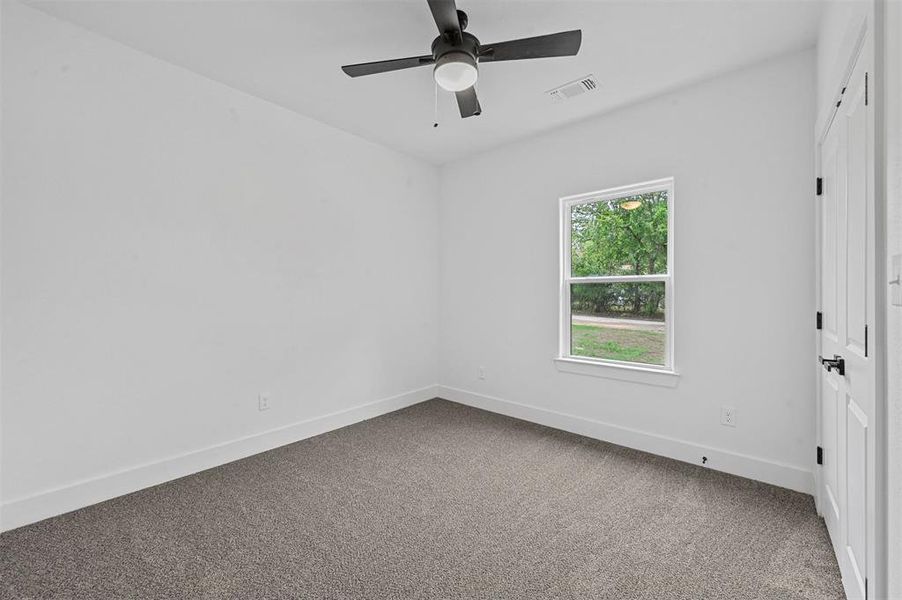 Spare room featuring ceiling fan and carpet