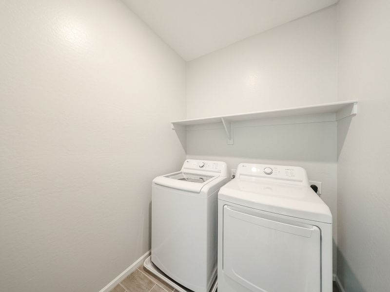 A washing machine in a room. A washing machine in a room.