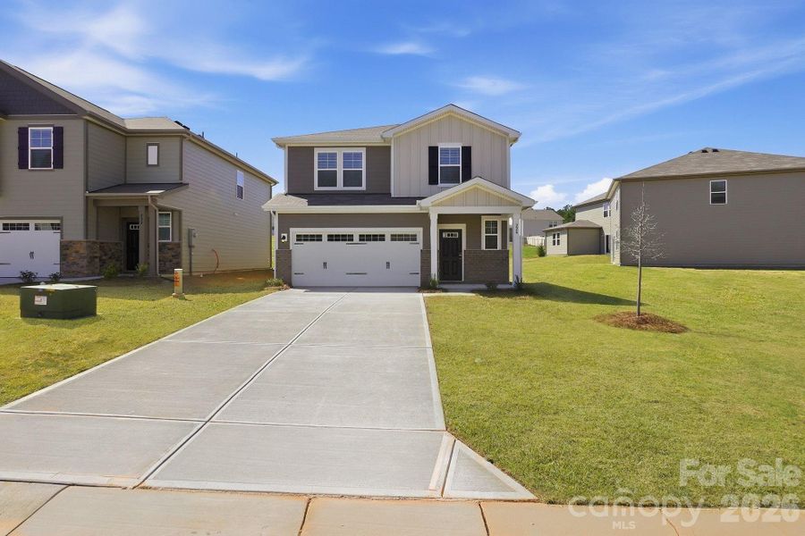 Front exterior of a new home in The Meadows at Asbury Ridge, York, SC, highlighting curb appeal (Image 1). Front exterior of a new home in The Meadows at Asbury Ridge, York, SC, highlighting curb appeal (Image 1).