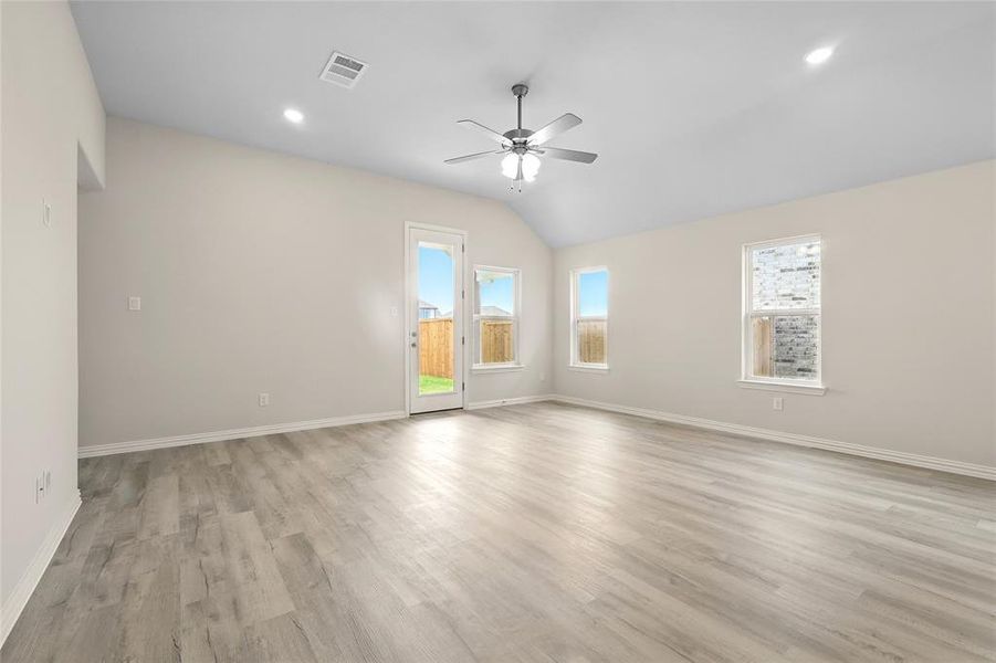 Unfurnished room with a ceiling fan, vaulted ceiling, light wood-style flooring, baseboards, and recessed lighting
