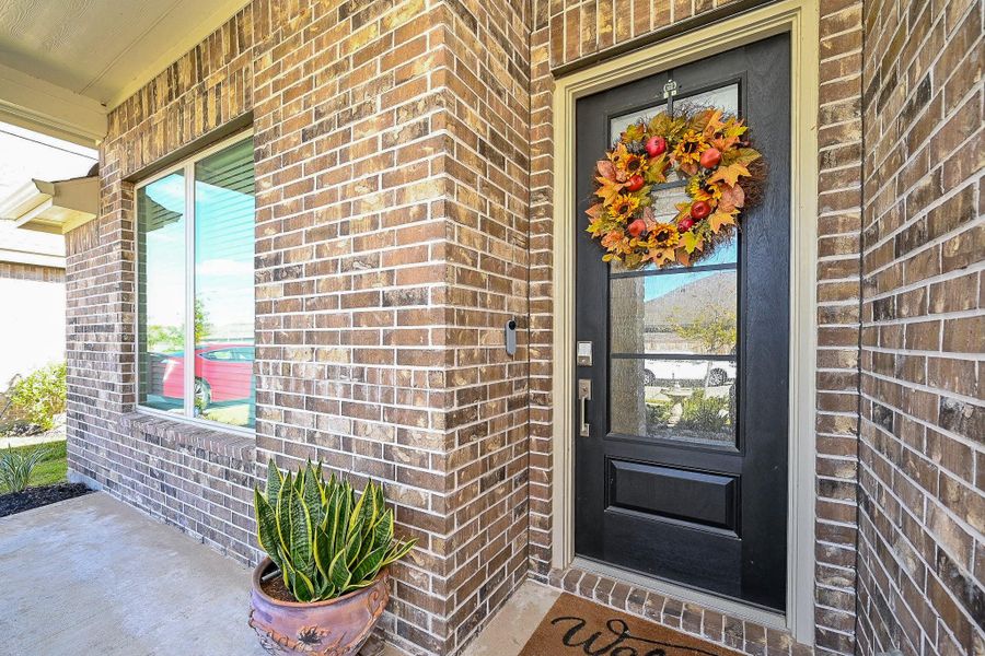 This inviting entryway blends classic brick architecture, the black front door serves as a bold focal point. This inviting entryway blends classic brick architecture, the black front door serves as a bold focal point.
