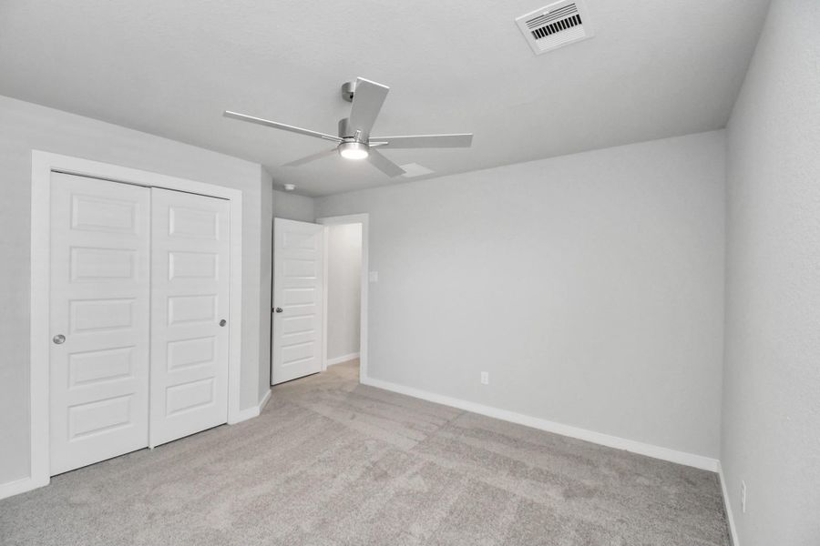 Generously sized secondary bedrooms featuring spacious closets, soft and inviting carpeting underfoot, large windows allowing plenty of natural light, and the added touch of privacy blinds for your personal retreat. Sample photo of completed home with similar floor plan. Actual colors and selections may vary. Generously sized secondary bedrooms featuring spacious closets, soft and inviting carpeting underfoot, large windows allowing plenty of natural light, and the added touch of privacy blinds for your personal retreat. Sample photo of completed home with similar floor plan. Actual colors and selections may vary.