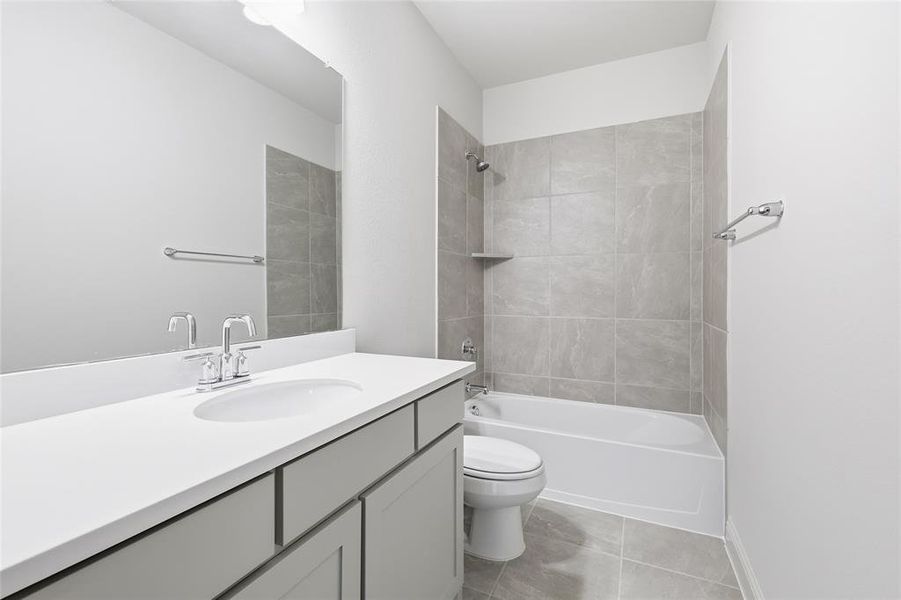 Bathroom featuring shower combination, vanity, and light tile patterned flooring Bathroom featuring shower combination, vanity, and light tile patterned flooring