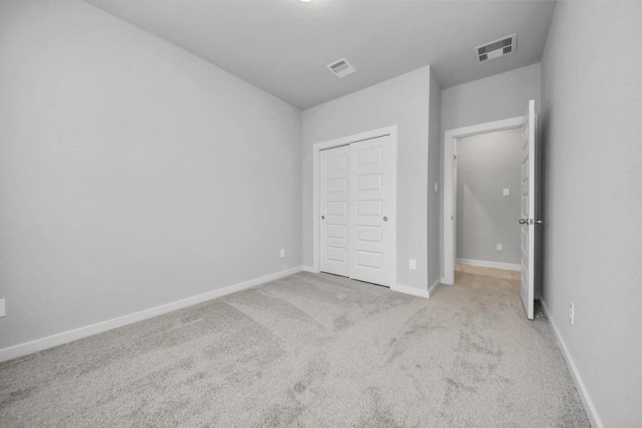 Inviting guest suite. The room features elegant 5-panel doors with sleek, contemporaryhardware. Sink your feet into the plush, fluffy carpet that invites comfort and warmth. Largewindows flood the space with an abundance of natural light, framed by privacy blinds thatoffer the perfect balance between openness and seclusion. Sample photo of completed home with similar floor plan. Actual colors and selections may vary. Inviting guest suite. The room features elegant 5-panel doors with sleek, contemporaryhardware. Sink your feet into the plush, fluffy carpet that invites comfort and warmth. Largewindows flood the space with an abundance of natural light, framed by privacy blinds thatoffer the perfect balance between openness and seclusion. Sample photo of completed home with similar floor plan. Actual colors and selections may vary.