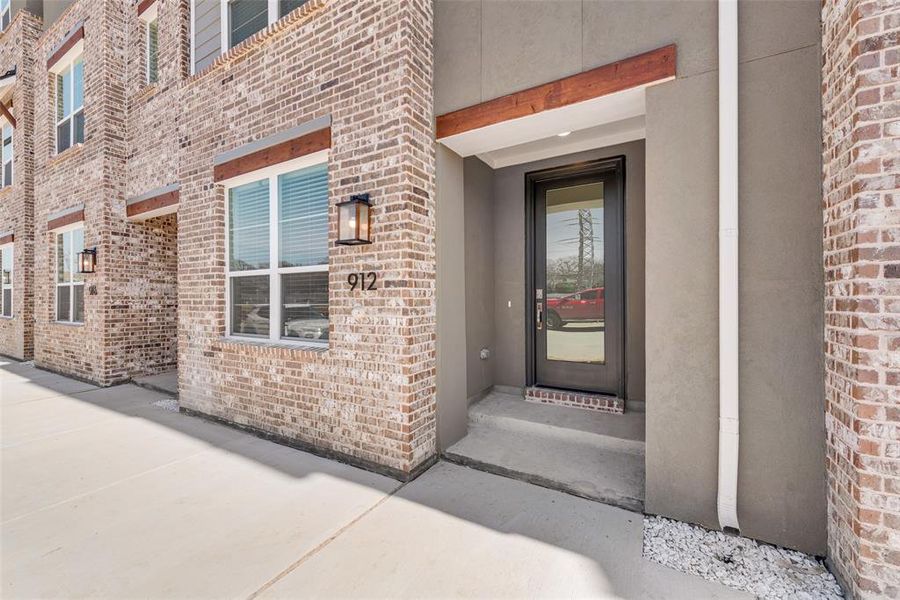 Front exterior of a new home in Collin Creek, Plano, TX, highlighting curb appeal (Image 1).