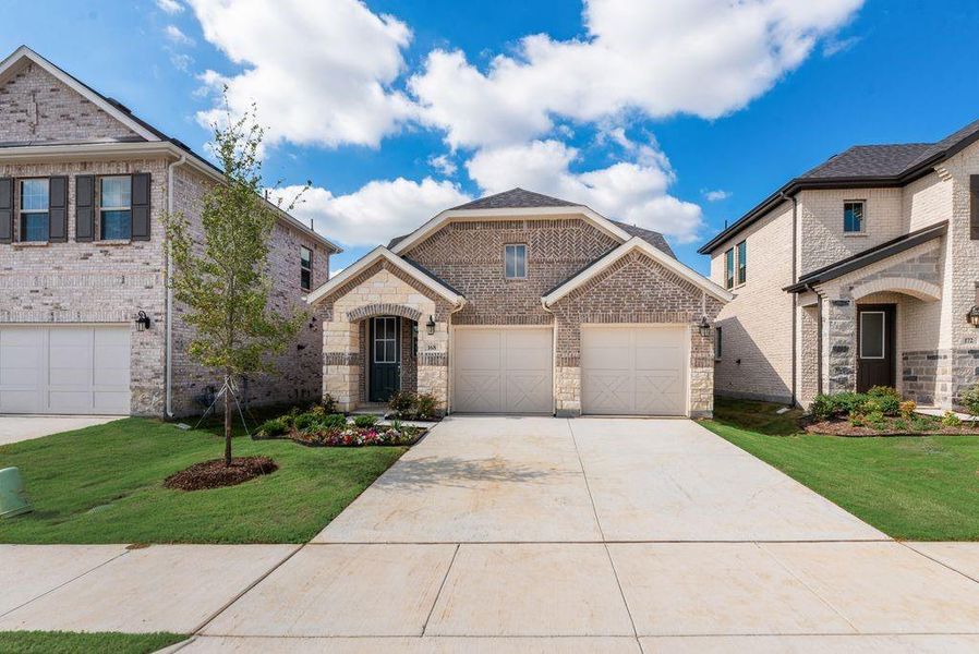 Front exterior of a new home in Spiritas Ranch, Little Elm, TX, highlighting curb appeal (Image 1). Front exterior of a new home in Spiritas Ranch, Little Elm, TX, highlighting curb appeal (Image 1).