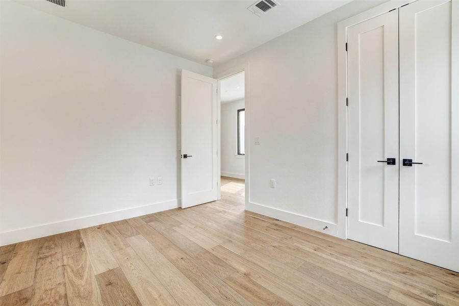 Unfurnished bedroom featuring light wood-style flooring and recessed lighting Unfurnished bedroom featuring light wood-style flooring and recessed lighting